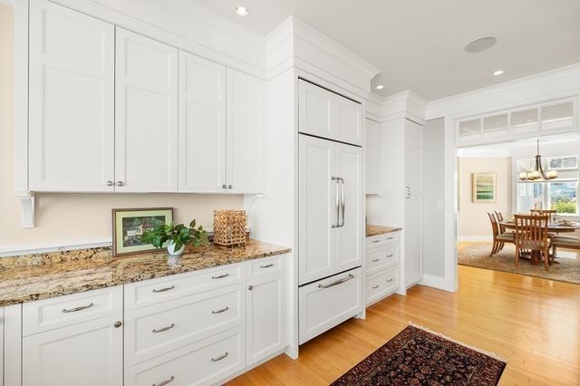 a kitchen with granite countertop white cabinets and white appliances