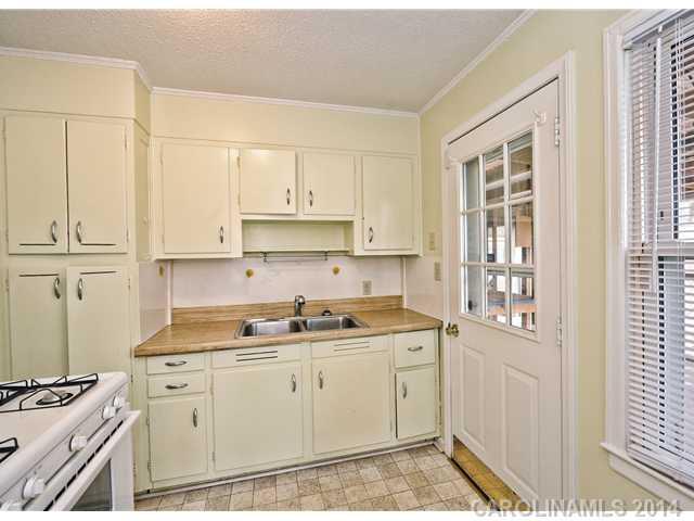 1465 Cortland Road West Charlotte, NC 28209 - Photo 5 of 10 a kitchen with stainless steel appliances granite countertop a sink stove and cabinets