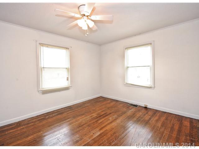 1465 Cortland Road West Charlotte, NC 28209 - Photo 6 of 10 an empty room with a window and a ceiling fan