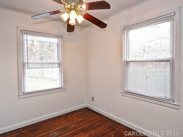 1465 Cortland Road West Charlotte, NC 28209 - Photo 7 of 10 a view of an empty room with wooden floor and a window