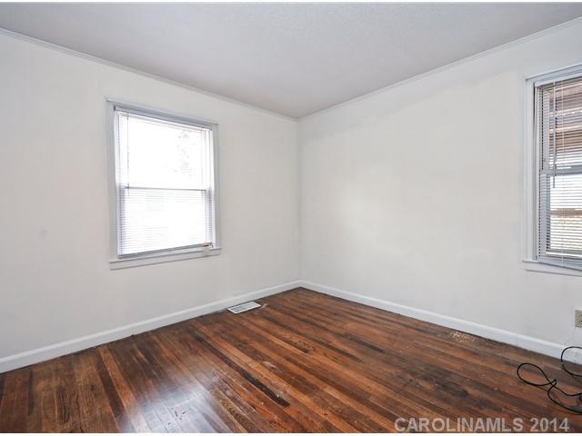 1465 Cortland Road West Charlotte, NC 28209 - Photo 8 of 10 an empty room with wooden floor and windows