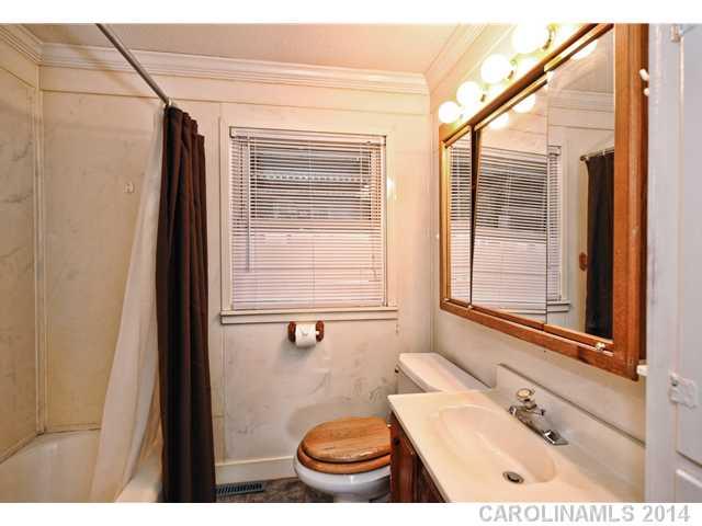 1465 Cortland Road West Charlotte, NC 28209 - Photo 9 of 10 a bathroom with a sink a toilet a mirror and shower
