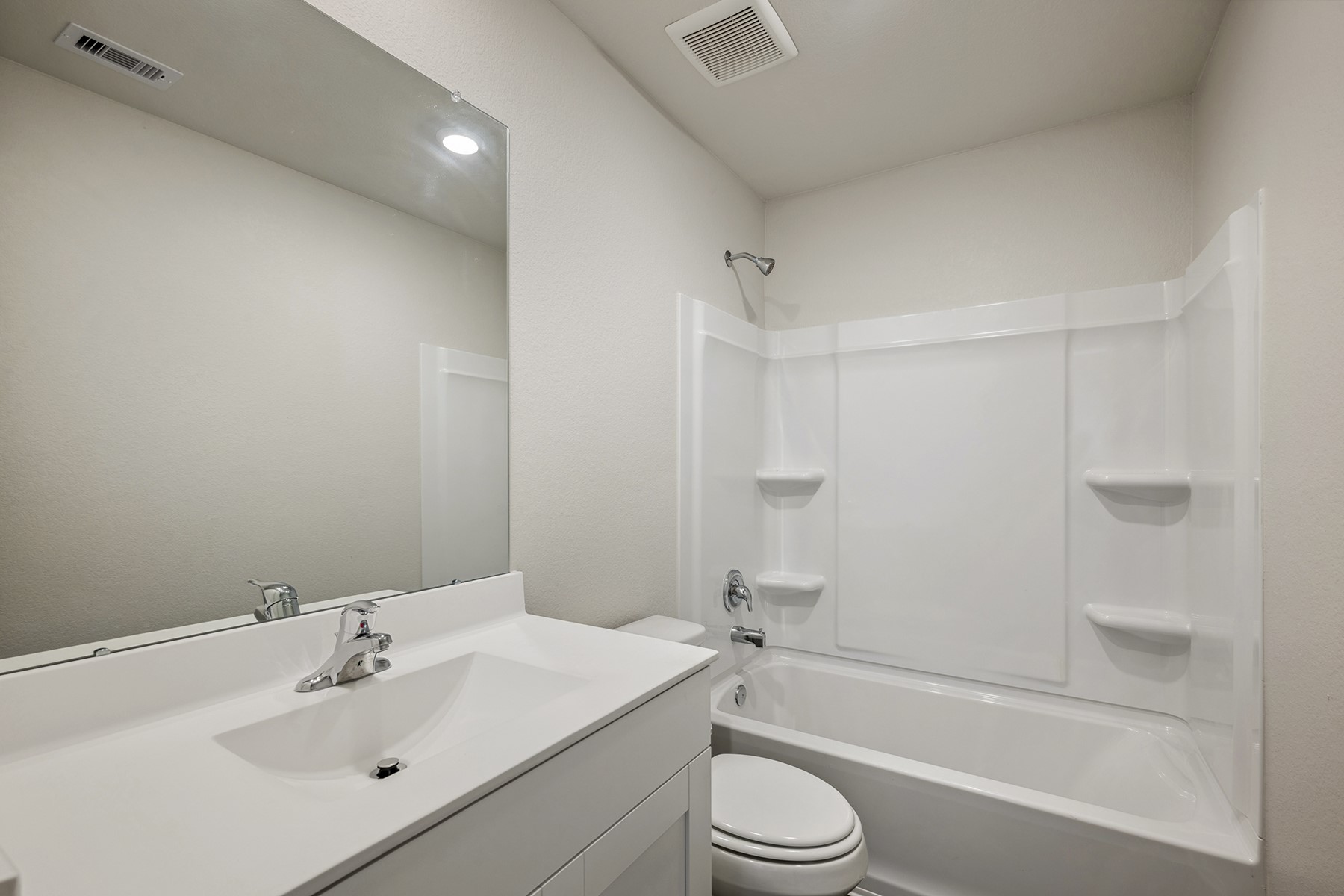 10430 Red Cardinal Drive Cleveland, TX 77328 - Photo 17 of 23 a bathroom with a bathtub shower sink vanity mirror and toilet