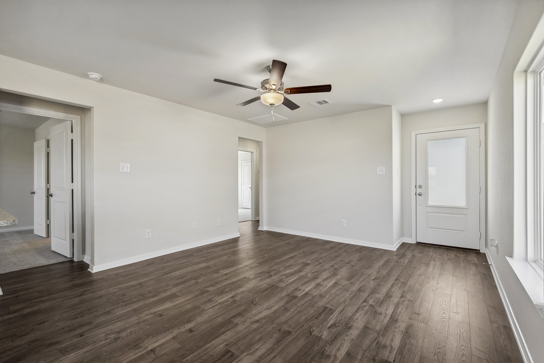 10430 Red Cardinal Drive Cleveland, TX 77328 - Photo 4 of 23 wooden floor in an empty room with a window
