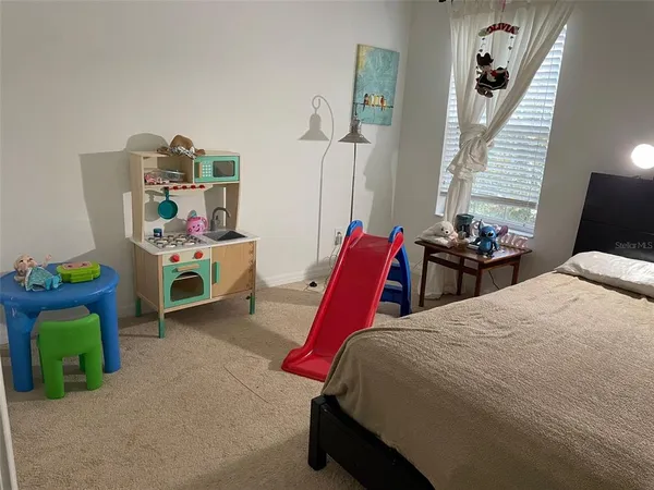 a bed room with a bed and a chair