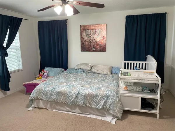a bedroom with a bed and a chandelier