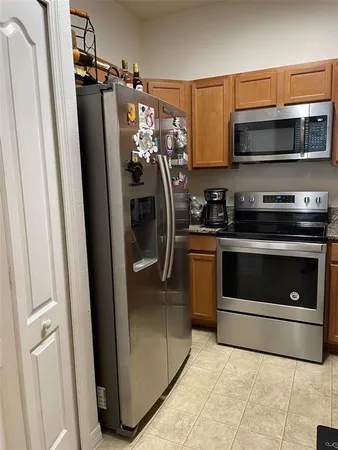 a kitchen with a stove microwave and refrigerator