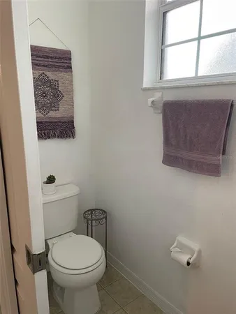 a bathroom with a toilet and a window