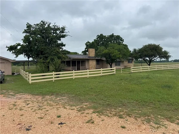 a front view of a house with a big yard