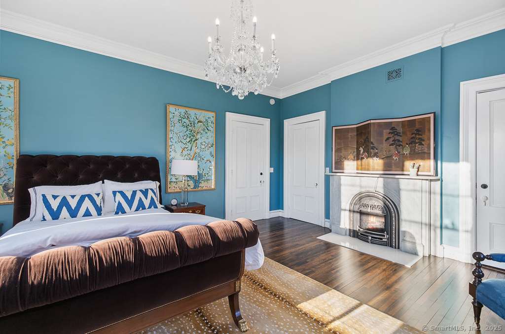 114 Walkley Hill Road Haddam, CT 06438 - Photo 18 of 28 a bedroom with a large bed and a fireplace
