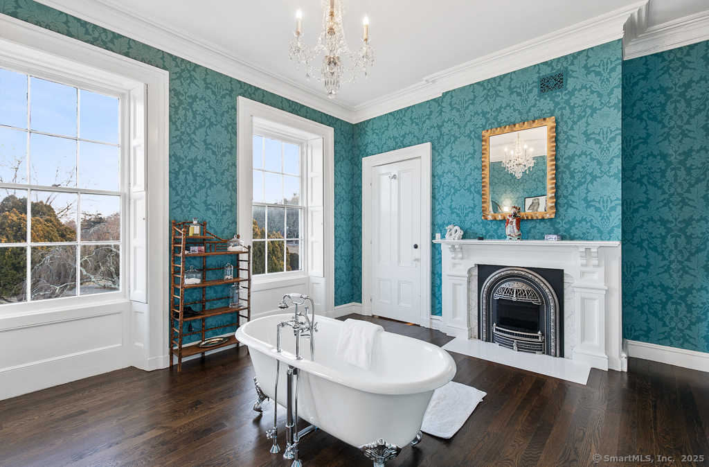 114 Walkley Hill Road Haddam, CT 06438 - Photo 20 of 28 a living room with furniture a fireplace and a floor to ceiling window