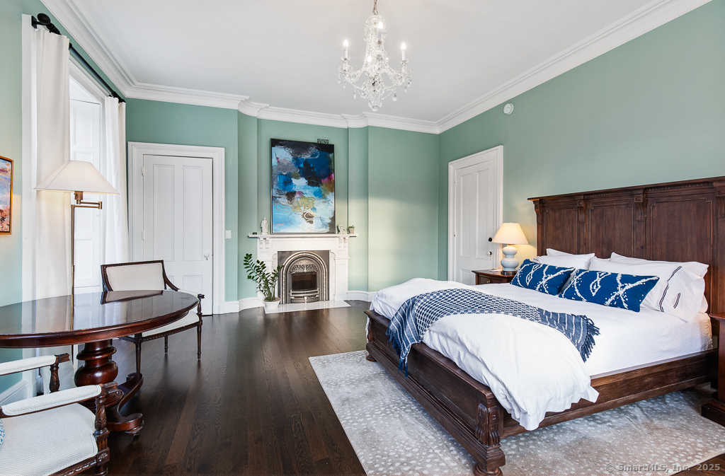 114 Walkley Hill Road Haddam, CT 06438 - Photo 21 of 28 a bedroom with a bed and a fireplace