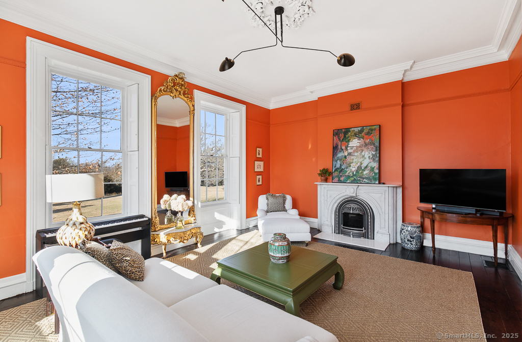 114 Walkley Hill Road Haddam, CT 06438 - Photo 7 of 28 a living room with furniture a flat screen tv and a floor to ceiling window