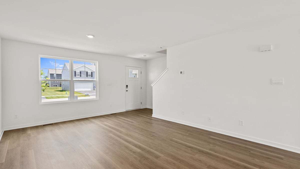 602 Adirondack Court Joliet, IL 60421 - Photo 2 of 16 a view of an empty room with wooden floor and a window