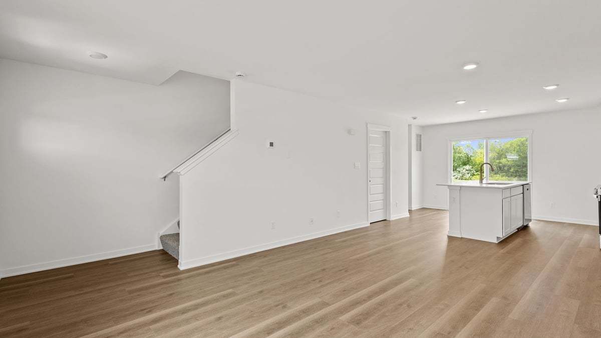 602 Adirondack Court Joliet, IL 60421 - Photo 6 of 16 a view of an empty room with wooden floor and a window