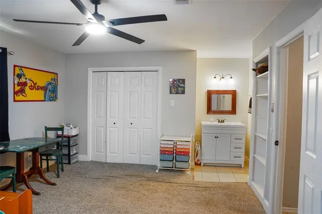 a spacious bedroom with a bed and a chandelier