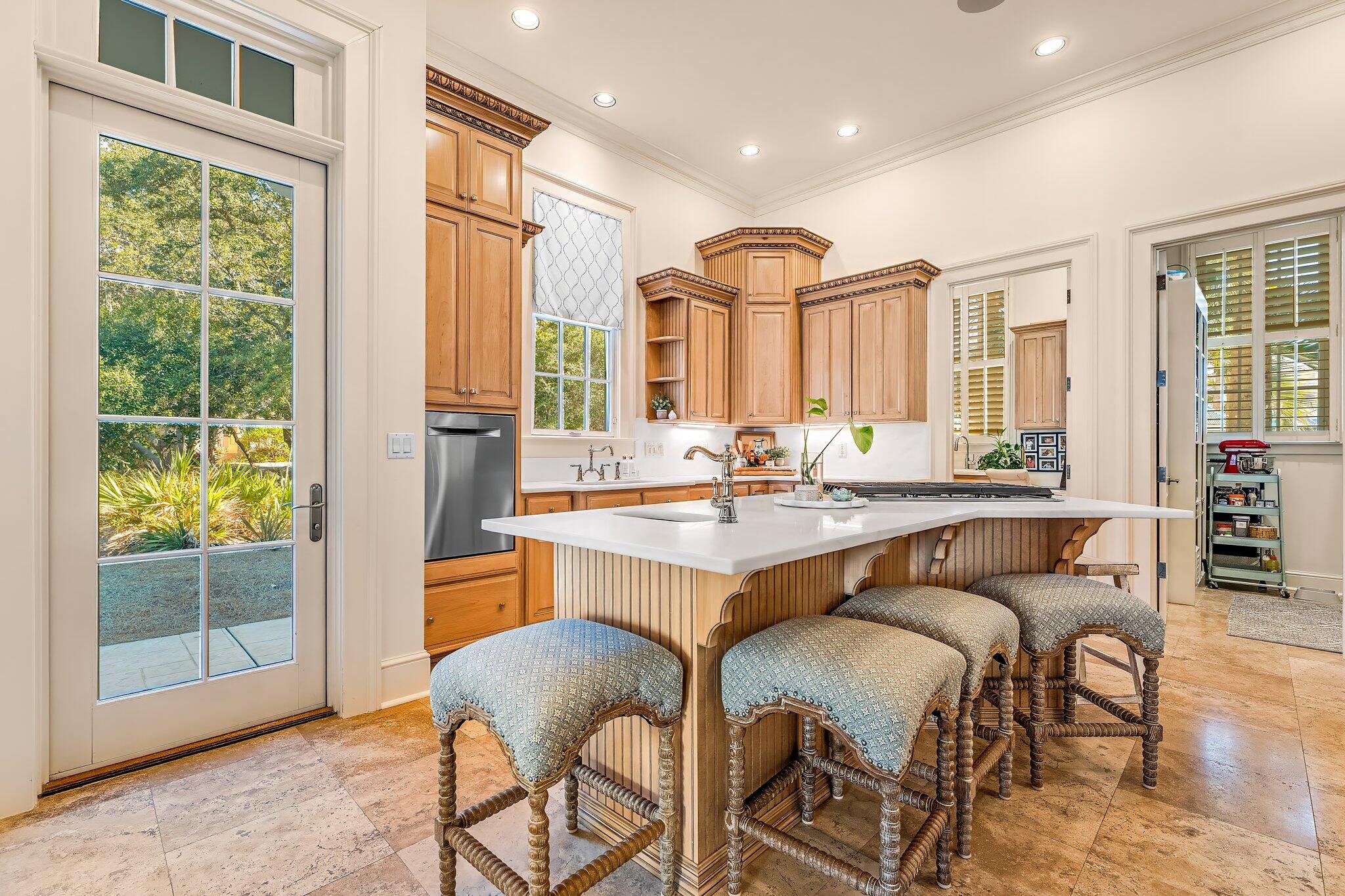 286 Rue Caribe Miramar Beach, FL 32550 - Photo 18 of 79 a dining hall with stainless steel appliances granite countertop a couch and a dining table with wooden floor