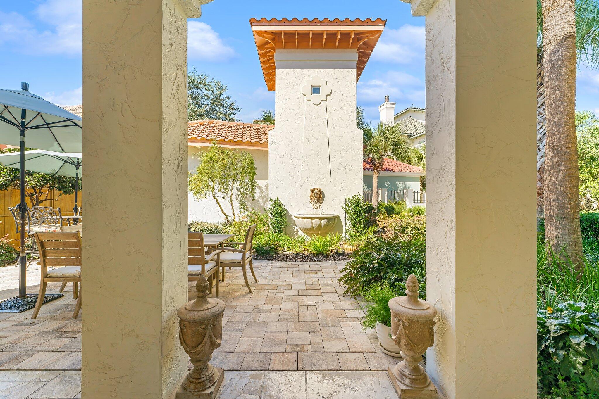 286 Rue Caribe Miramar Beach, FL 32550 - Photo 8 of 79 a view of a porch with chairs and potted plants