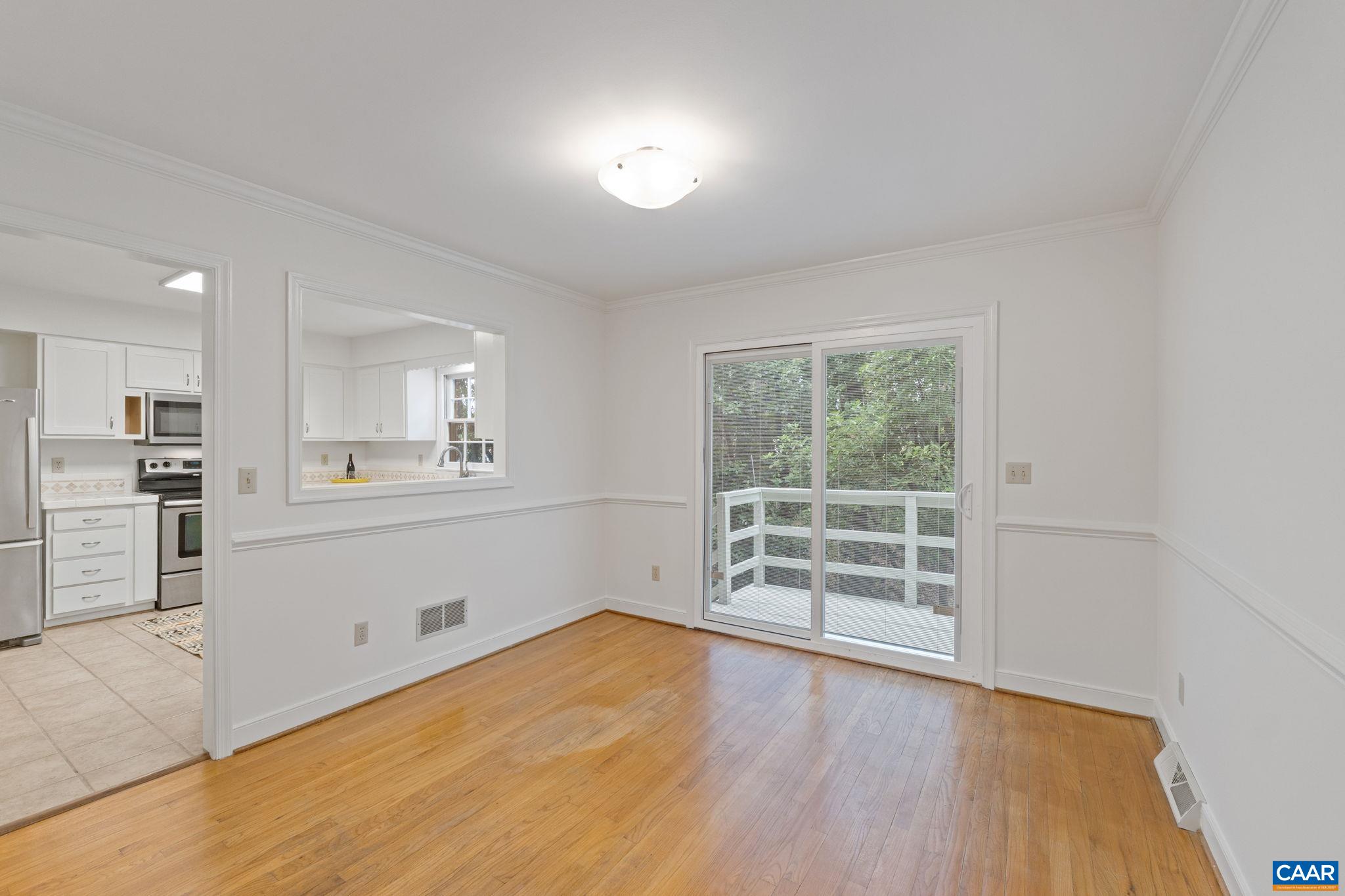2752 Hydraulic Road Charlottesville, VA 22901 - Photo 15 of 41 a view of a kitchen with wooden floor and a window