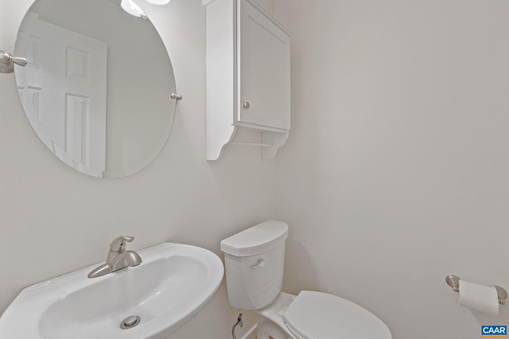 2752 Hydraulic Road Charlottesville, VA 22901 - Photo 16 of 41 a white toilet sitting next to a bathroom sink