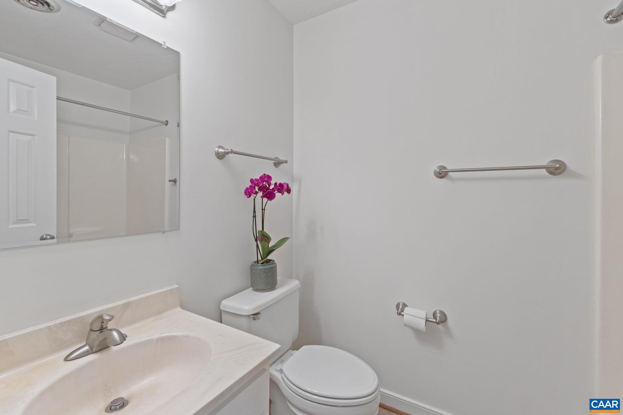 2752 Hydraulic Road Charlottesville, VA 22901 - Photo 23 of 41 a bathroom with a sink mirror vanity and toilet
