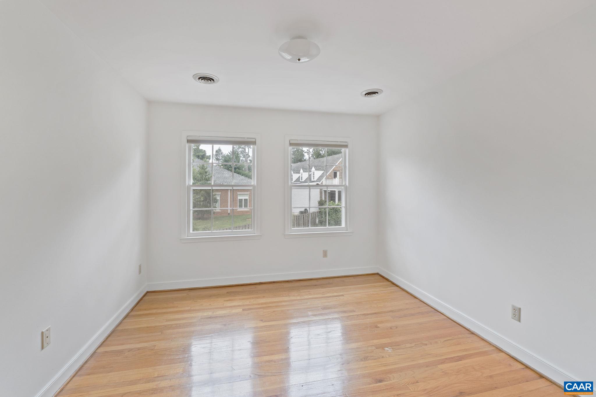 2752 Hydraulic Road Charlottesville, VA 22901 - Photo 25 of 41 a view of an empty room with wooden floor and a window