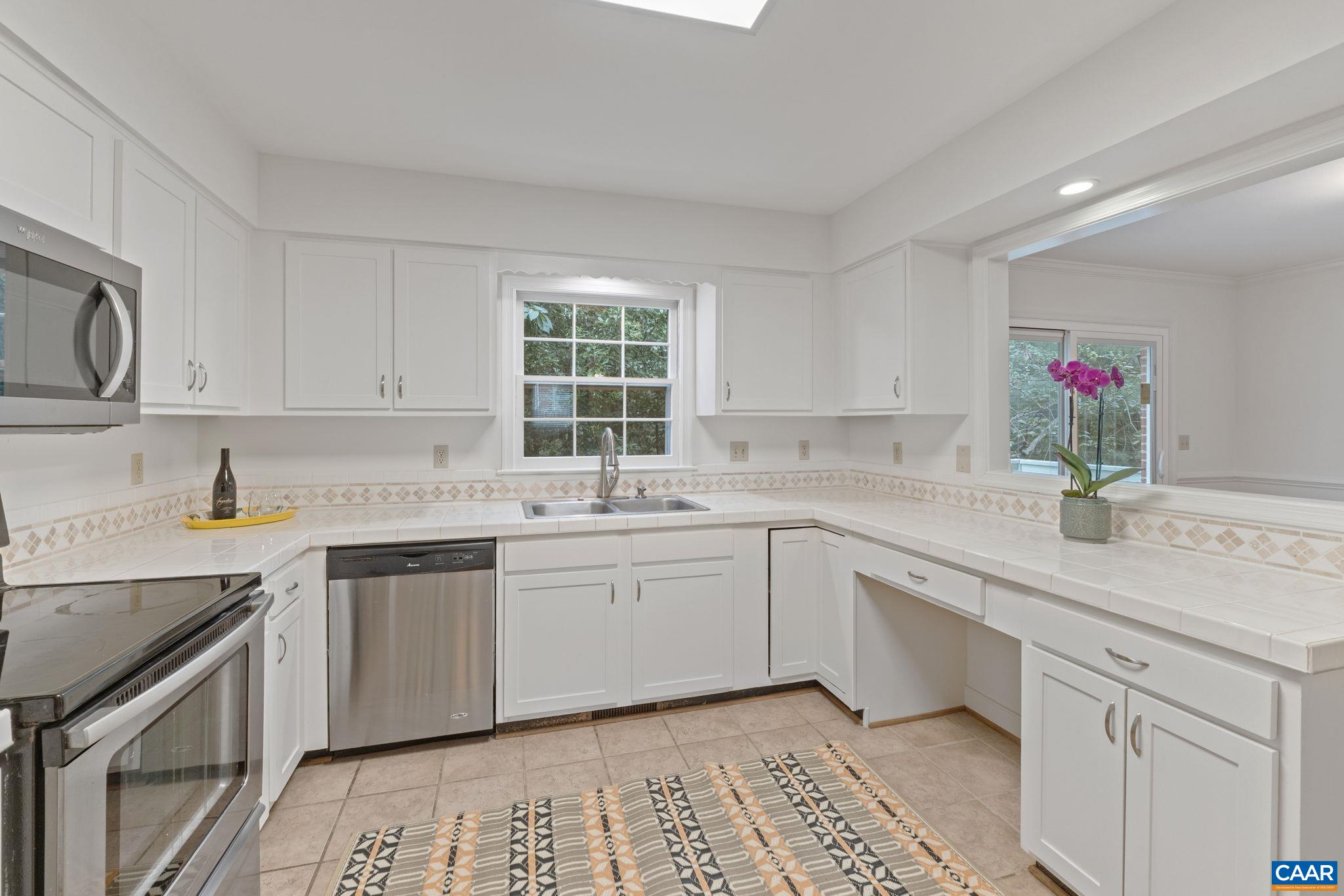 2752 Hydraulic Road Charlottesville, VA 22901 - Photo 4 of 41 a kitchen that has a sink and a stove in it