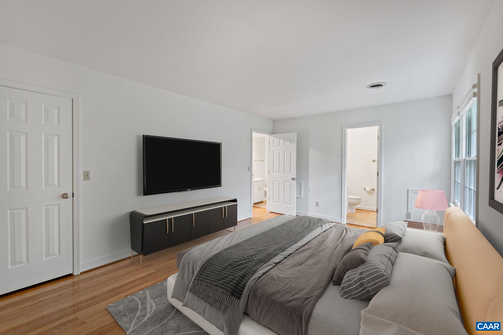 2752 Hydraulic Road Charlottesville, VA 22901 - Photo 6 of 41 a bedroom with a bed and a flat screen tv