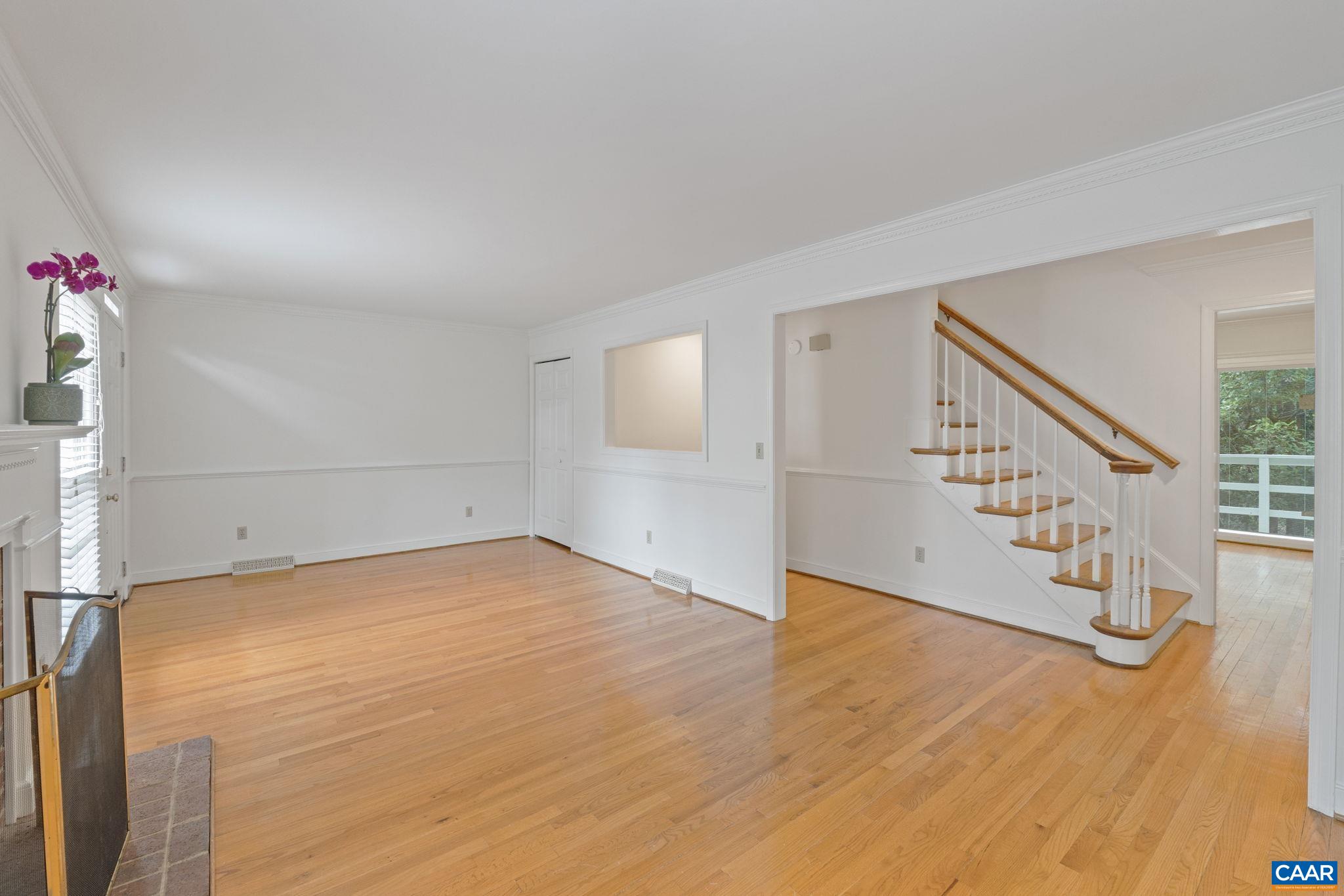 2752 Hydraulic Road Charlottesville, VA 22901 - Photo 8 of 41 a view of an empty room with wooden floor and stairs