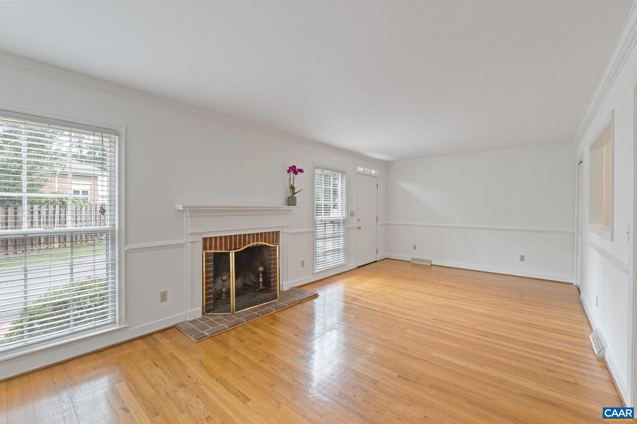 2752 Hydraulic Road Charlottesville, VA 22901 - Photo 9 of 41 a view of empty room with wooden floor and fireplace