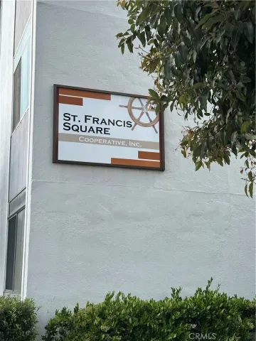 a sign on a wall next to a road