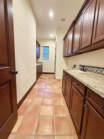 12410 Keith Road Beaumont, TX 77713 - Photo 21 of 45 a hallway with granite countertop stainless steel appliances sink and cabinets