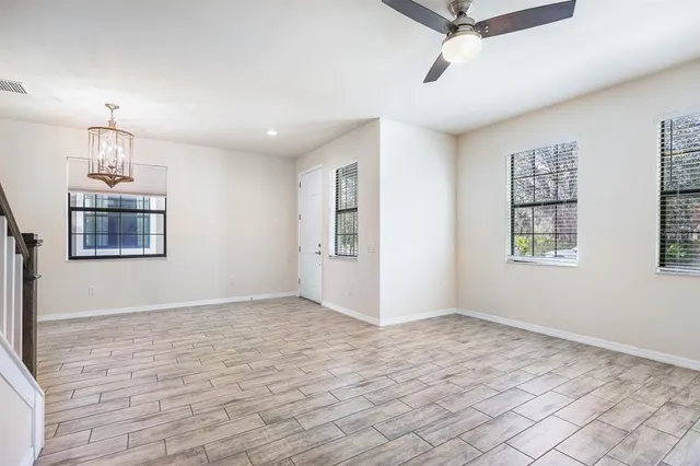 a room with gym equipment and large windows