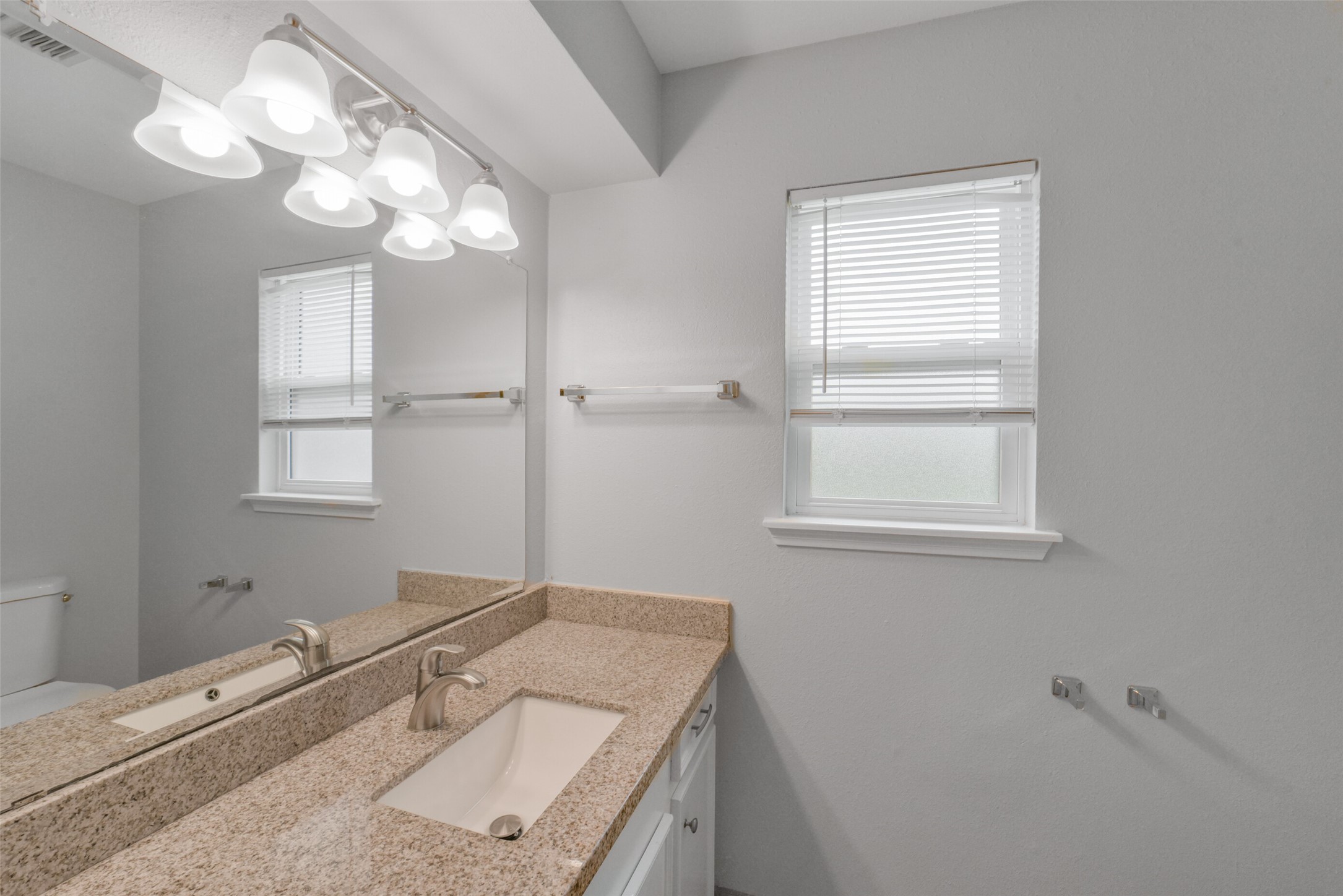 7611 Theisswood Road Spring, TX 77379 - Photo 25 of 41 The ensuite primary bathroom features a long sink vanity with ample counter space and walk in shower.