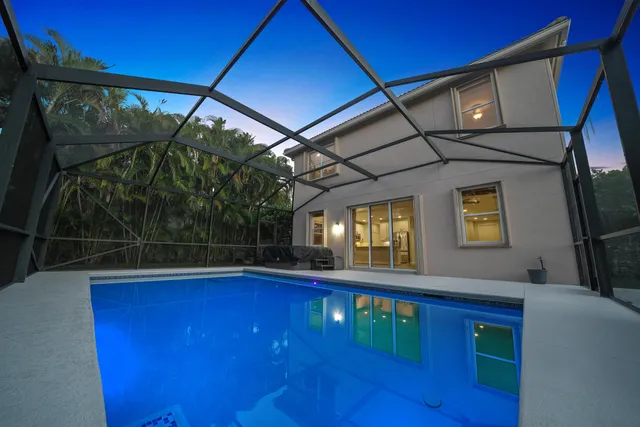 a living room with furniture and a view of kitchen