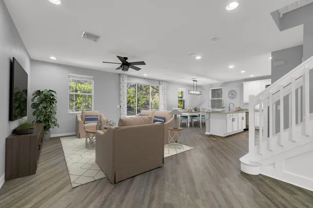 a kitchen with stainless steel appliances granite countertop a refrigerator a stove microwave and sink