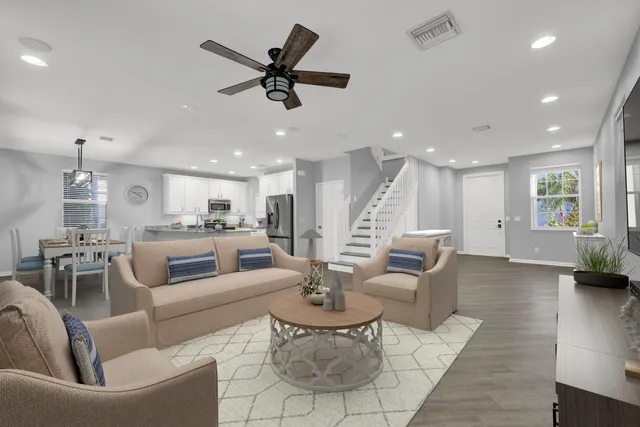 a kitchen with granite countertop white cabinets and white stainless steel appliances