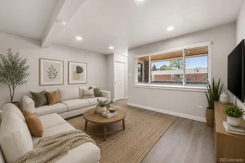 a living room with furniture potted plant and a window