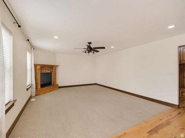 1279 West 1500th Street North Mapleton, UT 84664 - Photo 29 of 83 Spacious interior featuring a wood-finish fireplace, recessed lighting, and a ceiling fan