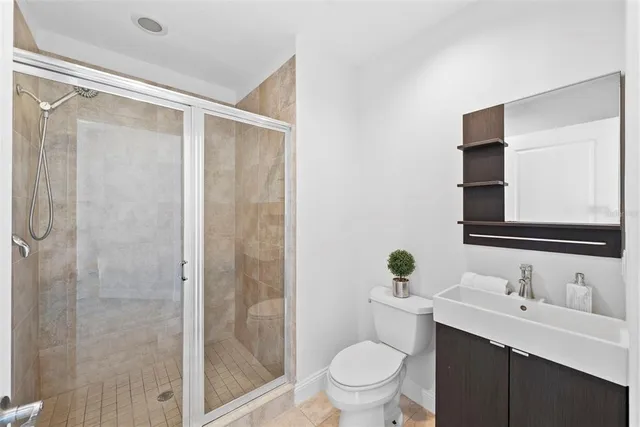 a view of an empty room with a fireplace and a window