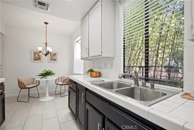 a kitchen with stainless steel appliances a sink stove and microwave