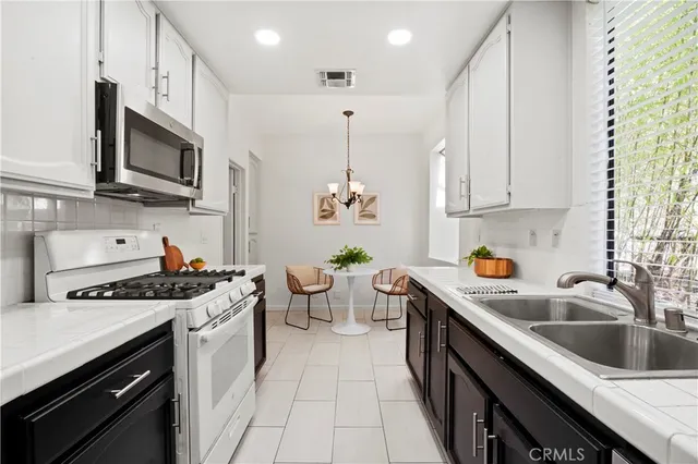 a kitchen with a table and chairs in it