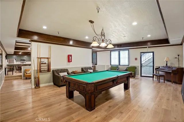a kitchen with stainless steel appliances granite countertop a sink a stove and a wooden floors