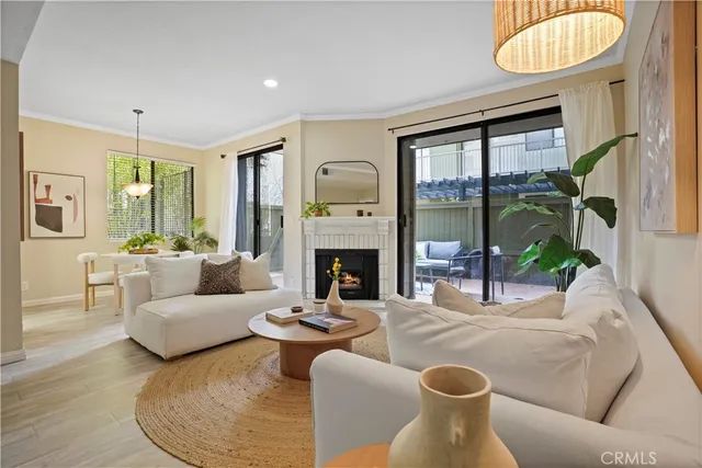 a dining room with furniture potted plants and wooden floor