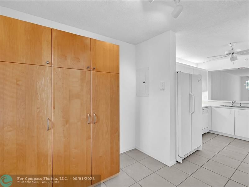 9551 Weldon Circle, Unit E311 Tamarac, FL 33321 - Photo 13 of 64 a view of a kitchen with white cabinets and wooden floor