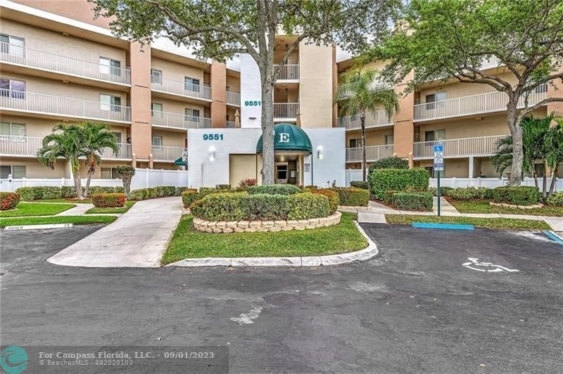 9551 Weldon Circle, Unit E311 Tamarac, FL 33321 - Photo 2 of 64 a view of outdoor space yard and front view of a building