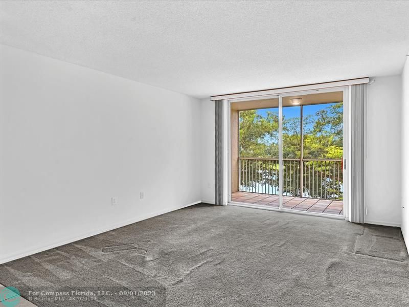9551 Weldon Circle, Unit E311 Tamarac, FL 33321 - Photo 21 of 64 a view of an empty room with a balcony