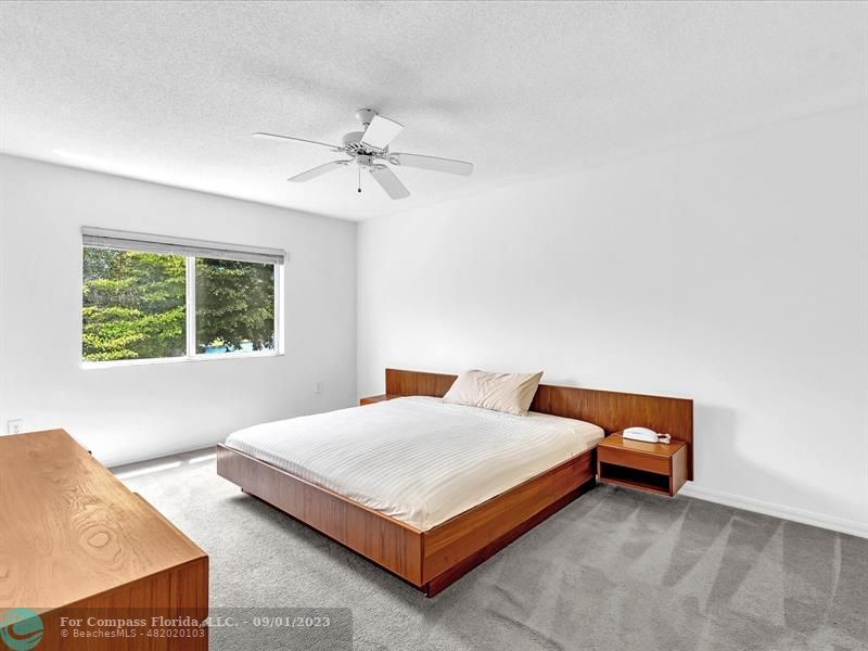 9551 Weldon Circle, Unit E311 Tamarac, FL 33321 - Photo 23 of 64 a bedroom with a bed and a window