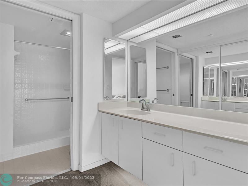 9551 Weldon Circle, Unit E311 Tamarac, FL 33321 - Photo 25 of 64 a bathroom with a double vanity sink and mirror