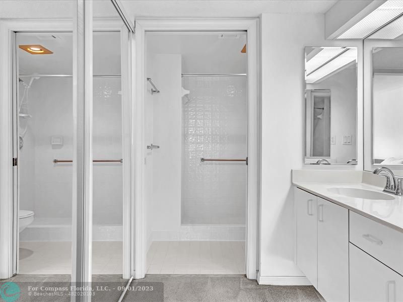 9551 Weldon Circle, Unit E311 Tamarac, FL 33321 - Photo 26 of 64 a bathroom with a shower sink and mirror